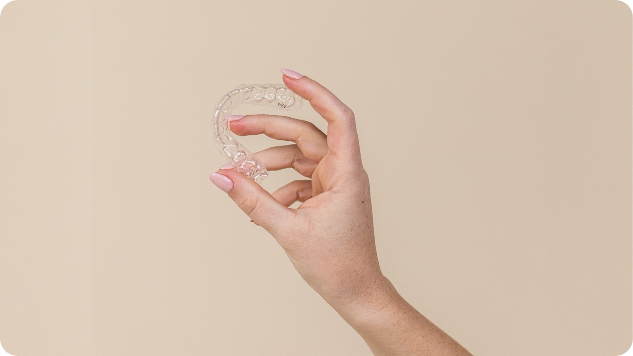 Clear retainer held up showing precision fit